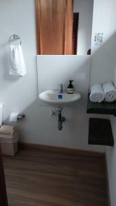 a bathroom with a sink and a toilet and towels at Caminos Alojamiento in Jardin +22 photos