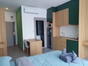 a bedroom with a bed with a stuffed animal on it at Terpenica - Rooms for Rent in Pattaya South +11 photos