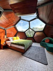 a room with a bed and a large window at Karuna Villa Prambanan in Yogyakarta