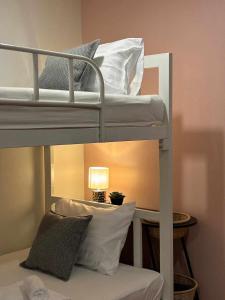 a couple of bunk beds in a room with a lamp at Comfy family room hatyai in Ban Khlong Pleo +3 photos