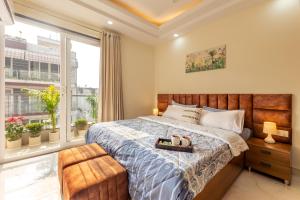 a bedroom with a large bed and a window at zest living sector 55 in Gurgaon