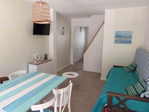 a living room with a blue table and a couch at Hermoso Duplex familiar en Zona Norte in Mar del Plata