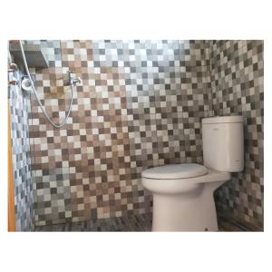 a bathroom with a toilet and a shower at Middle rooms surfhomestay in Airsatang