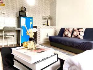 a living room with a couch and a coffee table at Impact Arena C75fl by GoodRoom24 in Ban Song Hong