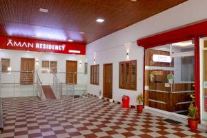 a lobby of a hospital with a checkered floor at AMAN Residency in Kallar Vattiyar