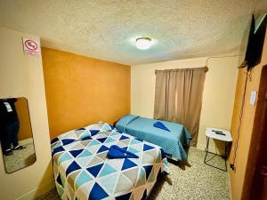 a small bedroom with a bed in a room at Hostal Sweet Dreams in Panajachel