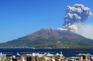 a volcano eruption over a city with a city at Aqua Garden Hotel Fukumaru in Kagoshima