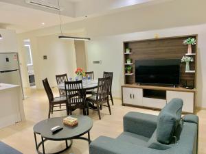 a living room with a couch and a table and a television at Star KLCC by Arman in Kuala Lumpur