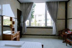 Postel nebo postele na pokoji v ubytování Thulee Luxury Hotel - Phu My