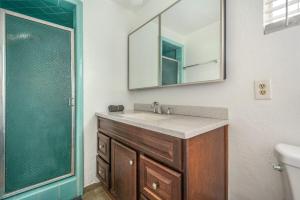 a bathroom with a sink and a mirror and a shower at Newly Renovated Home Spacious Close 2 Hospital in San Bernardino +19 photos