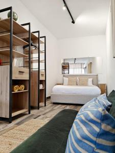 a bedroom with two beds and a book shelf at Fly Away Home condo with terrace in Qormi