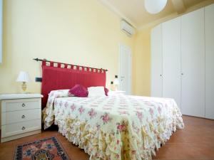a bedroom with a large bed with a red headboard at San Firenze in Florence