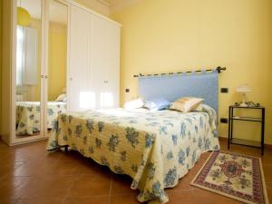 a bedroom with a bed with a blue headboard at San Firenze in Florence