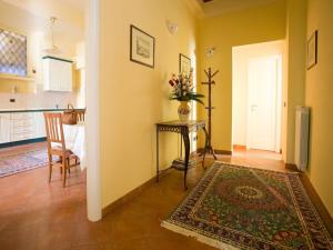 a living room with a table and a kitchen at San Firenze in Florence