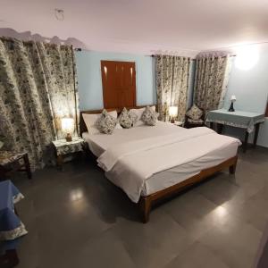 a bedroom with a large bed and a sink at Marwa House in Jaipur