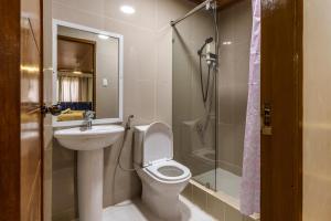 a bathroom with a toilet and a sink and a shower at Luxury Residence #1 Camp John Hay nr Eco Trails in Baguio +29 photos
