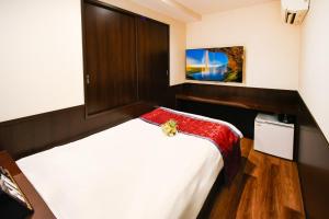 Postel nebo postele na pokoji v ubytování Ikebukuro Central Hotel
