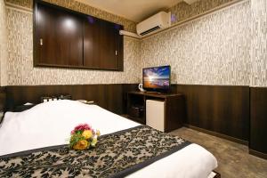 Postel nebo postele na pokoji v ubytování Ikebukuro Central Hotel