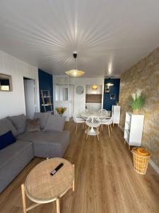 a living room with a couch and a table at Comme à la maison in Saint-Brieuc