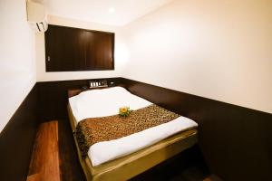 Postel nebo postele na pokoji v ubytování Ikebukuro Central Hotel