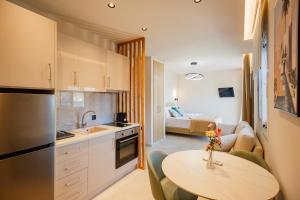 a kitchen with a table and a living room at Port View in Zakynthos