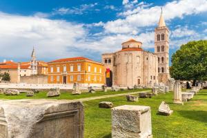 an old church and a church with a tower at Apartment Stefani Zadar - Balcony & Free Private Garage Parking in Zadar