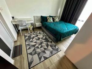 a bedroom with a bed and a desk and a table at Kenwingston Cyberjaya Wifi Free Parking in Cyberjaya +37 photos