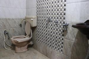 a bathroom with a toilet and a sink at Malama Stay Nisarg Villa 3BHK Karjat in Karjat
