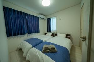 Postel nebo postele na pokoji v ubytování Inamine Terrace N