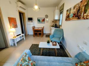 a living room with a blue couch and a table at Tavor view נוף תבור in Daverat