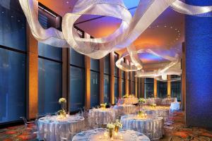 a dining room with tables with white table settings at The Westin Dallas Downtown in Dallas