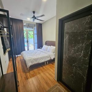 a bedroom with a bed in a room with a window at Sastred villa Mus'lim Only in Sungai Petani