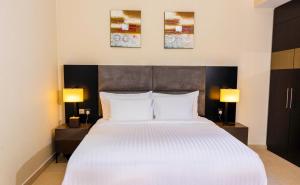 Postel nebo postele na pokoji v ubytování Jannah Executive Hotel Apartments + 29 fotografií