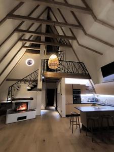 a living room with a fireplace and a dining room at Chalet Rafenstein in Moisei