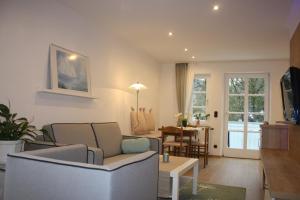 a living room with a couch and a table at Ferienwohnung am Ortenaupark in Bad Reichenhall