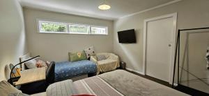 a room with a bed and a chair and a window at Bridge and Birds in Wellington