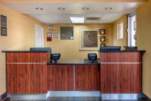 a waiting room with wooden cabinets and a counter at Comfort Inn & Suites Near Universal - N Hollywood - Burbank in Los Angeles +24 photos