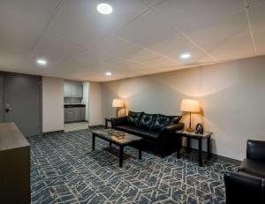 a living room with a couch and a table at Comfort Inn Falls Church - Tysons Corner in Falls Church