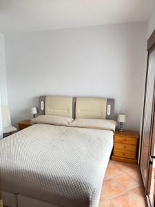 a bedroom with a bed with a large headboard at House Lago Azul in Cuevas del Almanzora +30 photos