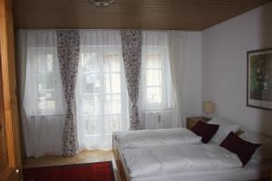 a bedroom with two beds in front of a window at Ferienwohnung am Ortenaupark in Bad Reichenhall