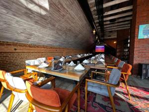 a dining room with wooden tables and chairs at Dad Residence in Lankaran