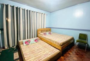 Postel nebo postele na pokoji v ubytování RedDoorz Hostel at MRC Residences Baguio