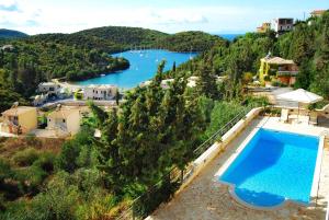a swimming pool with a view of a lake at Niriides Luxury Apartments in Syvota