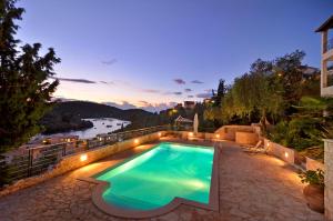 a swimming pool with a view of a river at Niriides Luxury Apartments in Syvota