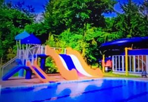 a playground with a slide at a park at Knusse bungalow met binnen en buitenzwembad op het park in Ermelo