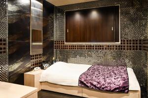 Postel nebo postele na pokoji v ubytování Ikebukuro Central Hotel