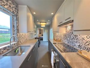a kitchen with a sink and a counter top at The Cozy Quaint Fort in Puyallup