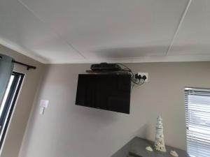 a flat screen tv on the wall of a room at Anreith Close in West Point