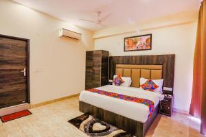 a bedroom with a large bed in a room at FabHotel The Kiara Near IGI Delhi Airport in New Delhi