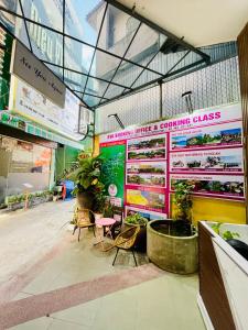 a room with chairs and plants in a store at Eva Homestay in Hue